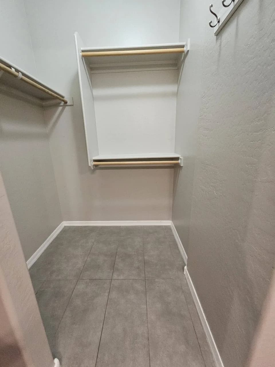 Clean empty closet with shelving and tile floor from New Star Cleaning work