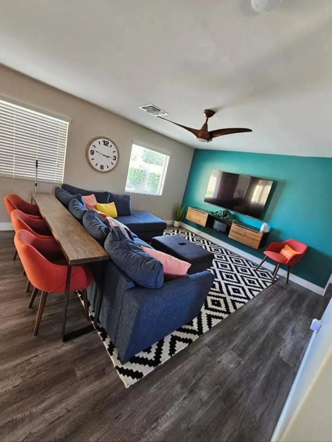 Clean living room with sectional, rug, and wood-look floors from a New Star appointment