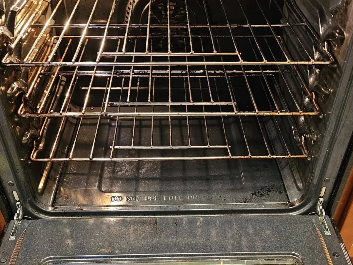 The same oven interior with cleaned racks and floor after detail work
