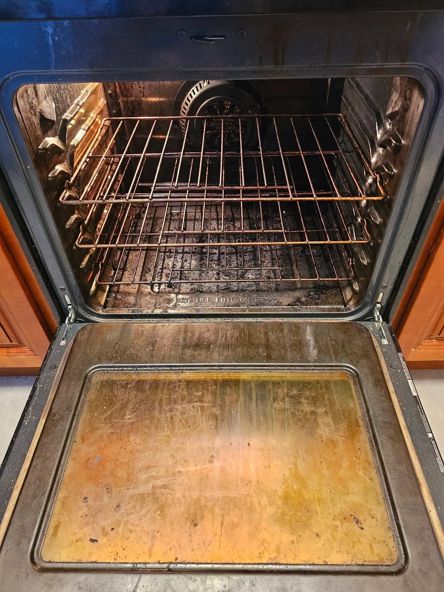 Oven interior with heavy grease and burnt buildup before New Star cleaning
