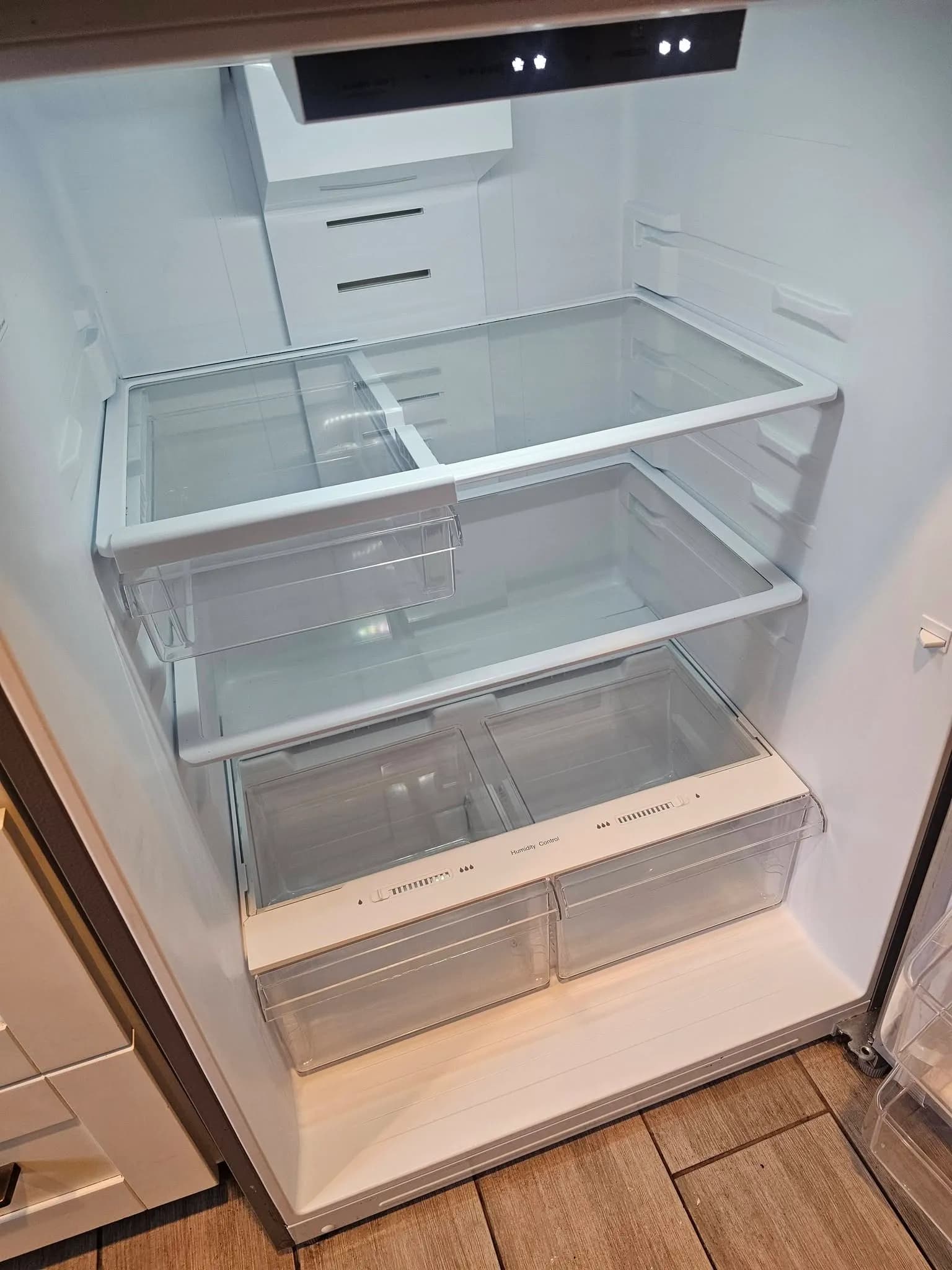 Clean empty refrigerator interior after a New Star empty-home cleaning