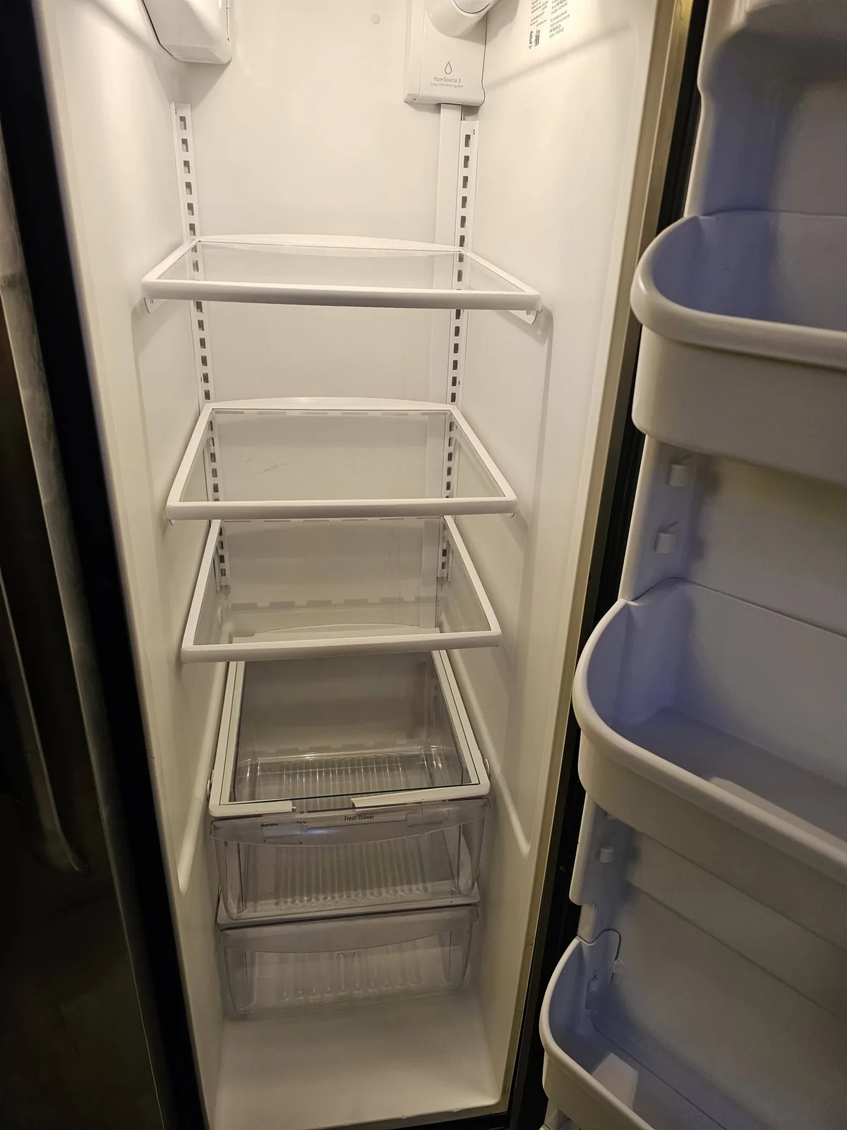 The same refrigerator interior with clean shelves and drawers after cleaning